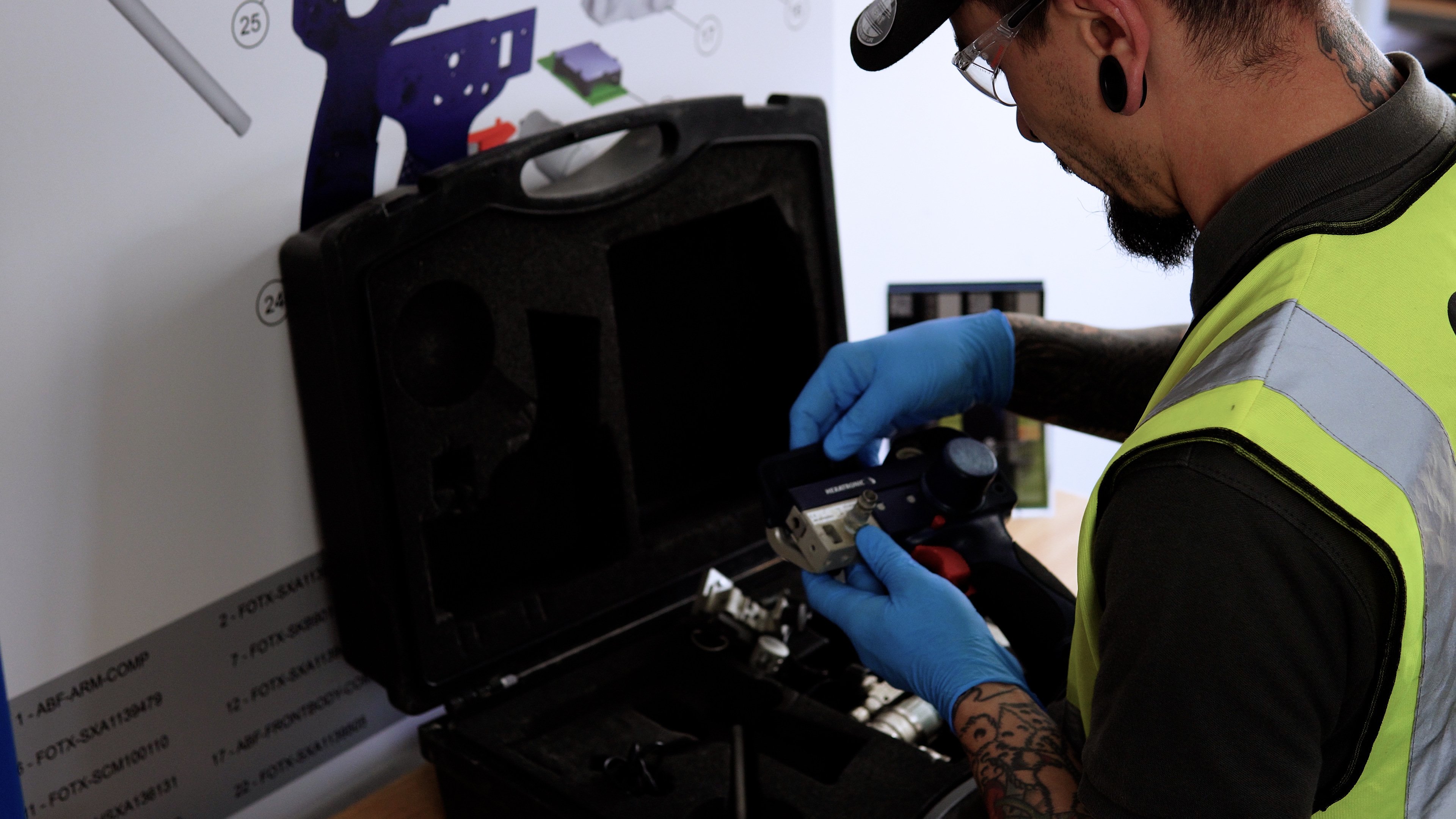 Person servicing fiber installation equipment.